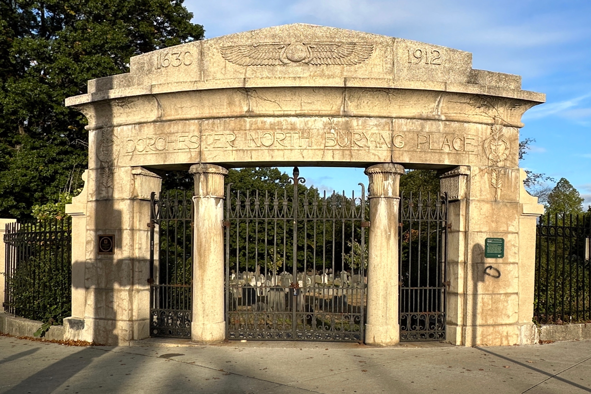 setting sunlight hitting the LockedDorchester North Burying Ground Gate. 