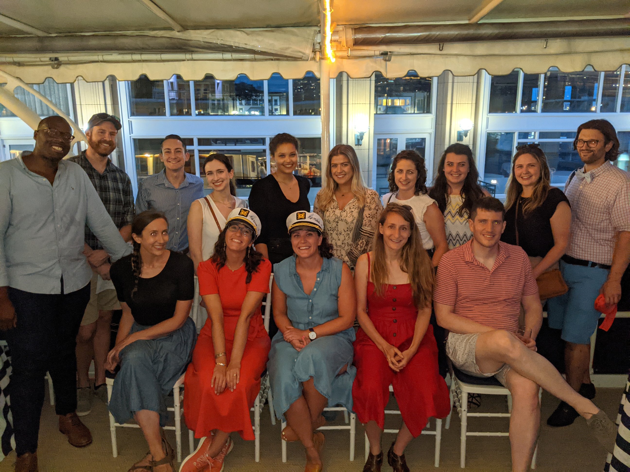 Young advisors posing together on a boat.
