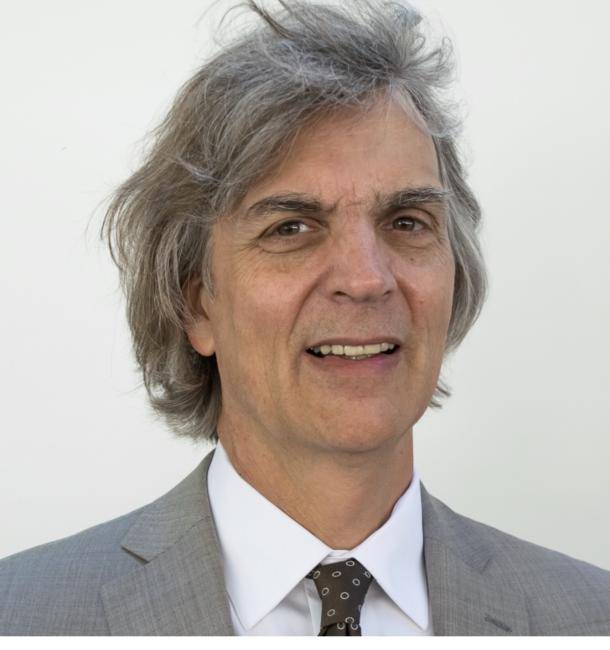 Michael Cannizzo looking straight ahead in grey suit.